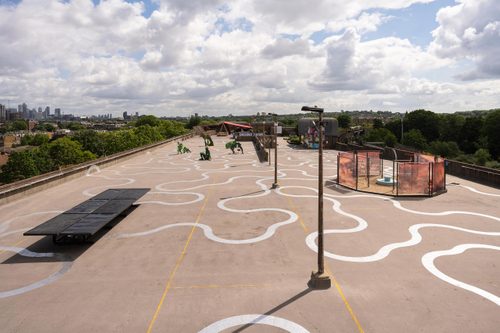 A concrete rooftop full of sculptures, seen from an elevated viewpoint.