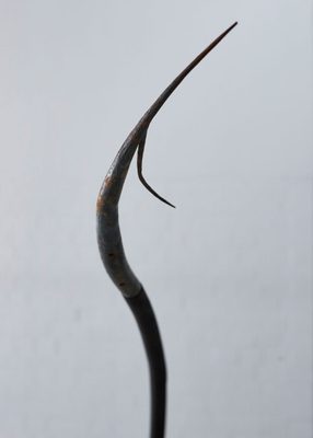 Close up view of a slightly rusted metal harpoon tip.