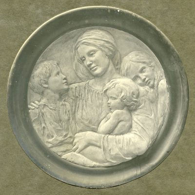 A circular relief sculpture of a woman surrounded by three small children.