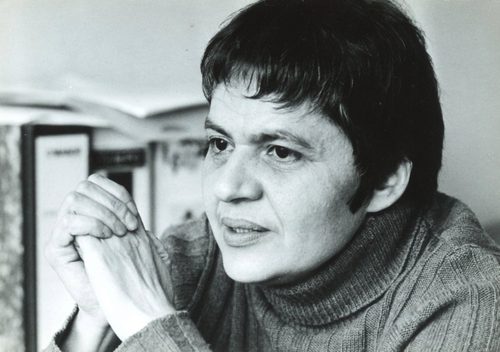 Black and white portrait photo of a middle-aged woman with short, dark hair.