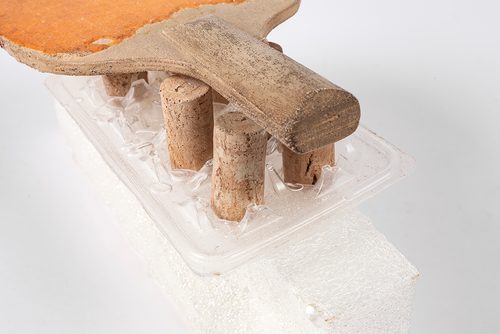 A sculpture of a table tennis on a stand which appears to be made from upright bottle corks