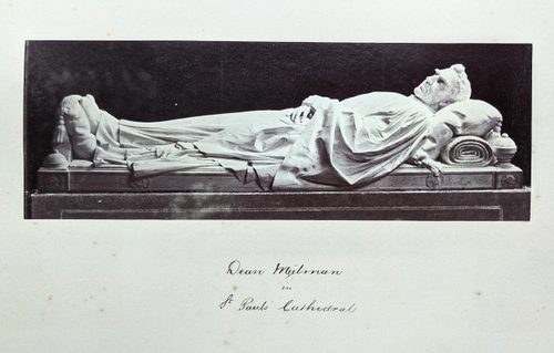 Black and white photo of a figurative tomb sculpture of a man, lying in repose as though asleep.