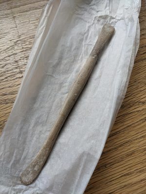 A wooden modelling tool.