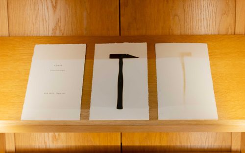 Display case with three prints. The first reads 'CERES (fifteen burnt images), Keir Smith, August 1980'. The second appears to be the shadow of a hammer; the third is possibly the same hammer, but much more faded.