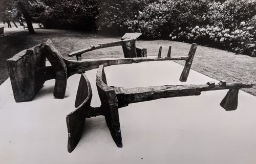 Black and white photo of three abstract sculptures by Geoffrey Clarke, photographed outdoors in a park. They look somewhat like ploughs or other agricultural equipment.