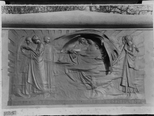 Black and white photo of a relief sculpture depicting several figures, one of whom is ascending to heaven with angels.