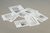Photograph of nine slim newspapers strewn haphazardly together in a pile on the gallery floor. Titled 'Floor with All Existing Words', they were made by artist Mark Manders and contain every word in the English language, each word printed only once.