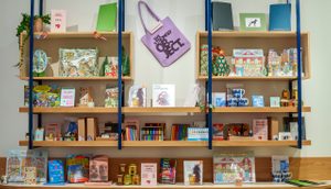 Shelving racks filled with books and art supplies, decorated with a Christmas theme.