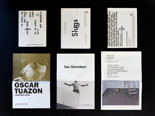 Display of six typographical artworks - pages of printed material that have been manipulated and printed on top of - set on a black background.