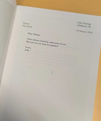 An open book, with a page laid out in the style of a latter. The message reads: 