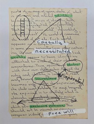 A page of handwritten text, with several words highlighted in green. These have been used as nodes to draw shapes over the text. Tip-ex has been used on top to create three prominent word banners, which read 'causally necessitated Free will'.