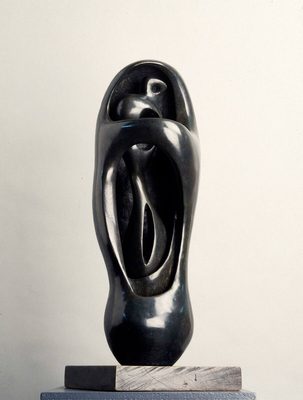 A black sculpture by Henry Moore of a standing figure encased in an oval 'shell'.