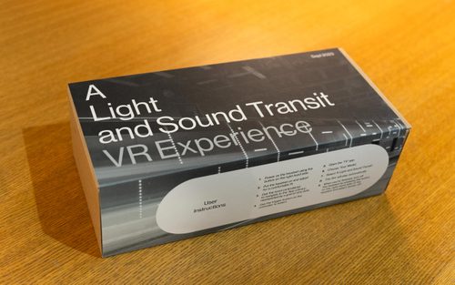 A boxed VR headset, with a custom sleeve that reads 'A Light and Sound Transit VR Experience', with user instructions.